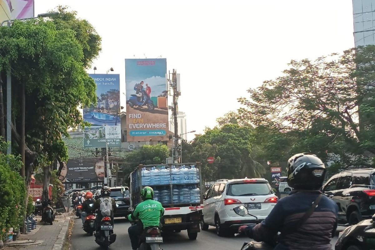 a group of people on motorcycles and cars on a street